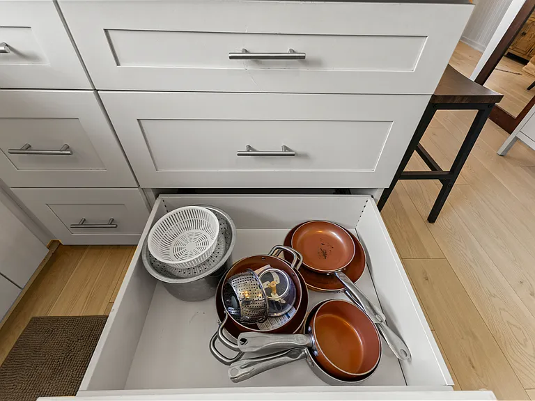 The kitchen is open to the living room and features plenty of storage and counter space, a ceiling fan, full size refrigerator with water station, oven, microwave and dishwasher. The kitchen is fully equipped.