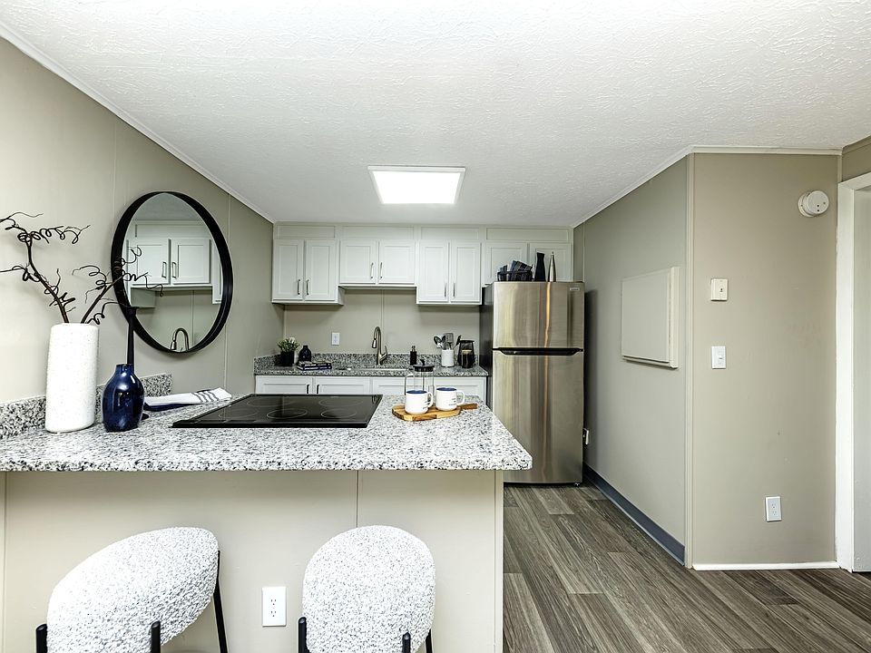 Bright kitchen with granite countertops and stainless steel appliances
