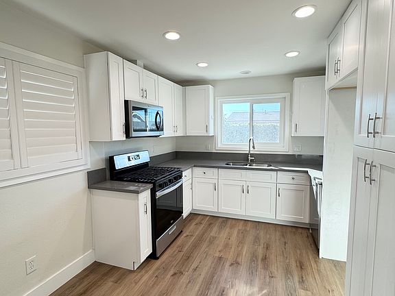 Beautiful, bright, white updated kitchen with quartz counters, lots of storage, updated gas range
