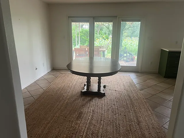 Dining room look in the the back yard from these sliding foors. Carpet gives you some scale. It is a 10x12.