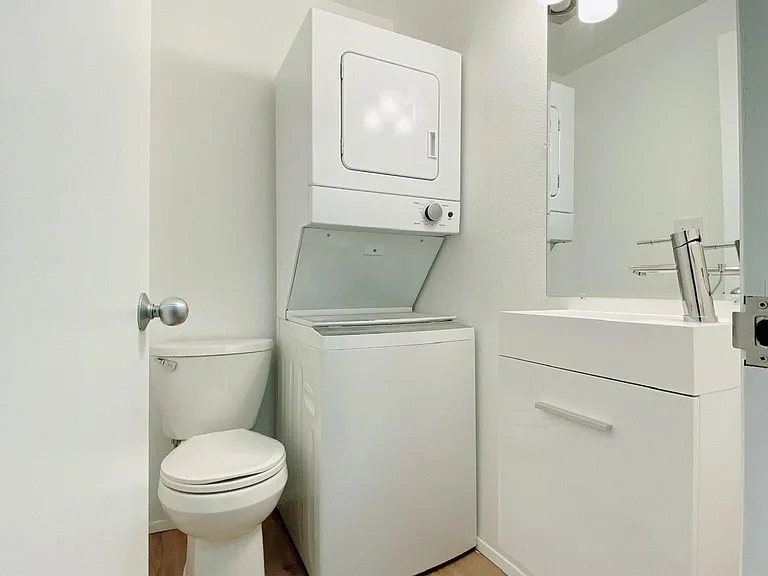 1st floor powder room (half bath) with stackable laundry machine