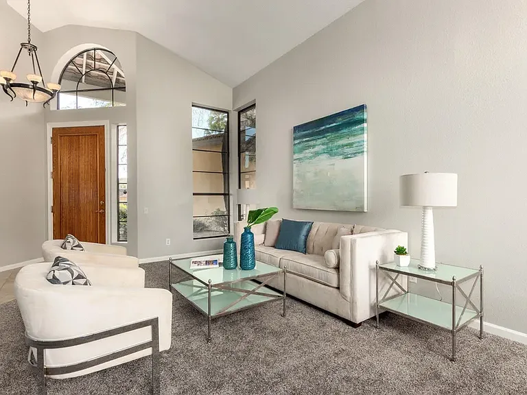 Double-story high living room with formal dining overlooking the backyard fountain