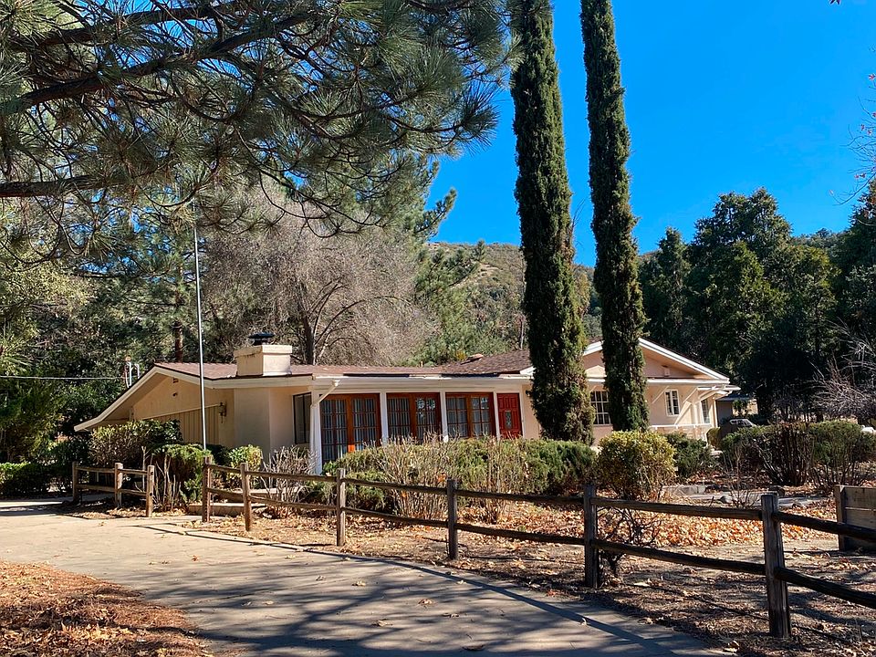 Front of home with Italian cypress trees