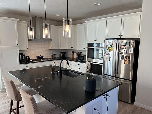 Sleek and modern kitchen with upgraded and smart appliances (digital double oven).