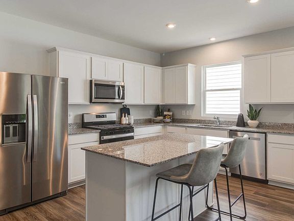 Spacious Kitchen with classic white cabinets.