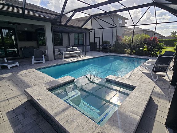 Huge screened-in lanai with spa and pool, TV hookup, great for relaxing or entertaining!