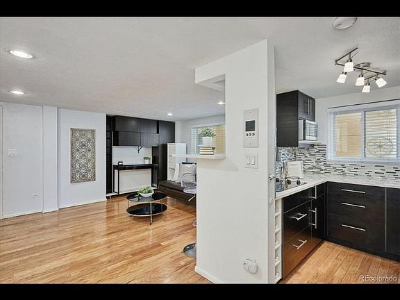 Walking through the main living space, the fluency from the living area to the kitchen area, to the adjacent dine-in area (as shown in another image) gives one the feeling of an "open loft design". There are NO walls blocking the beauty within!