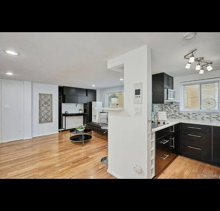 Walking through the main living space, the fluency from the living area to the kitchen area, to the adjacent dine-in area (as shown in another image) gives one the feeling of an "open loft design". There are NO walls blocking the beauty within!