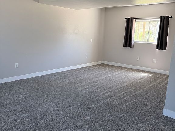 Downstairs family room with additional storage under the stairs and a hallway closet.