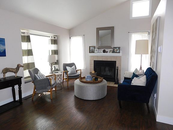 Front living room with vaulted ceilings and an abundance of natural light! *Living room fireplace is not available for use at this time*