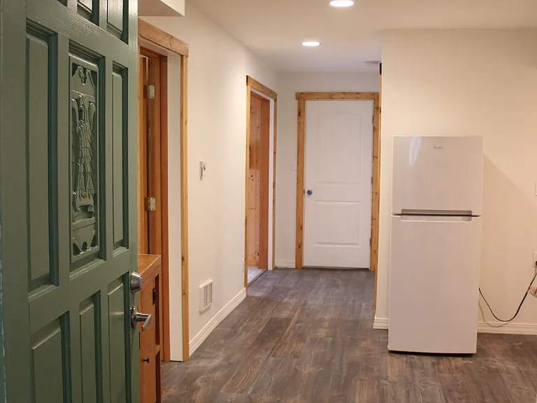 Green front door opens into hallway and kitchen.
