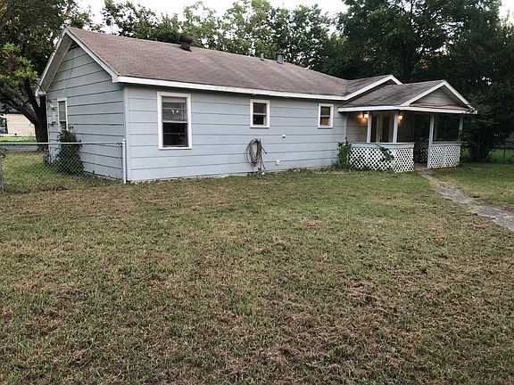 Large fenced back yard with storage shed.