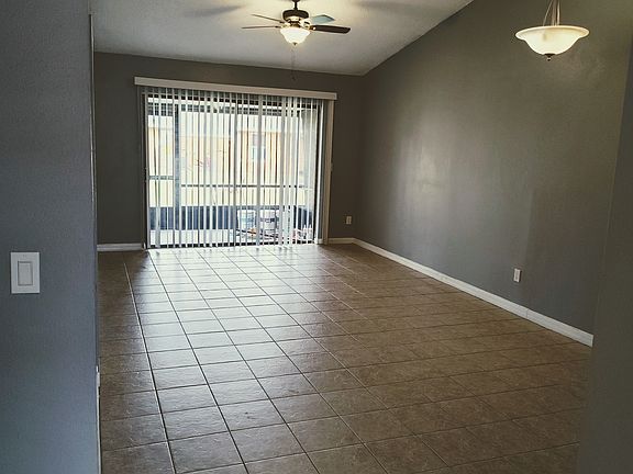 Spacious living room and screened back patio leading to nice field area