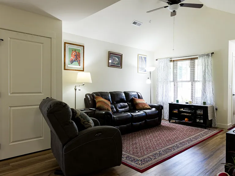 Living room with vaulted ceilings and fan