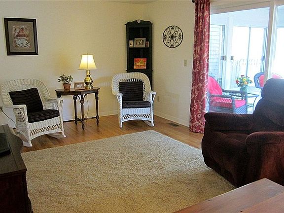 The Greatroom is the entire width of the Townhome, boasts the gorgeous, original red oak hardwoods, a neutral dcor and steps out to the 3-Season Room!