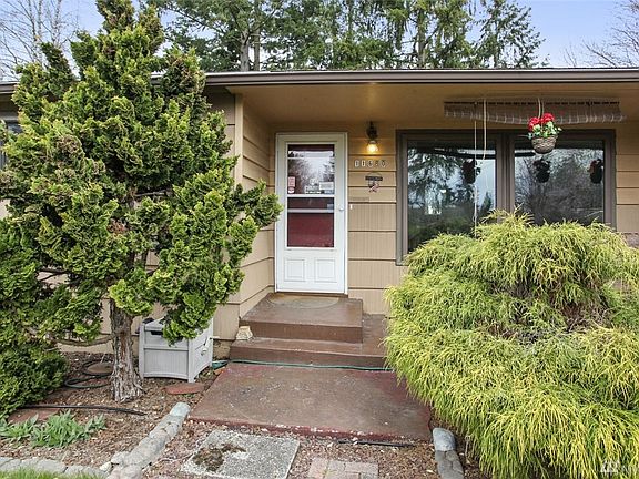 The front door welcomes you into the living room with hardwood floors.