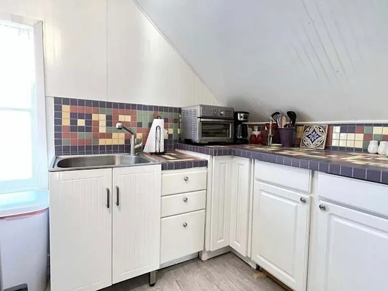 Private kitchenette with refrigerator, small appliances but no stove/range.