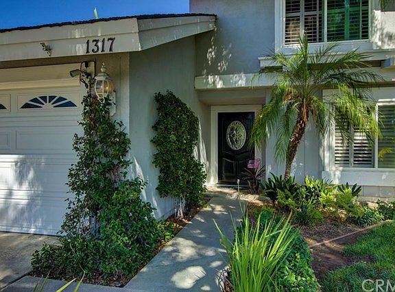 Newer front door with leaded glass window.