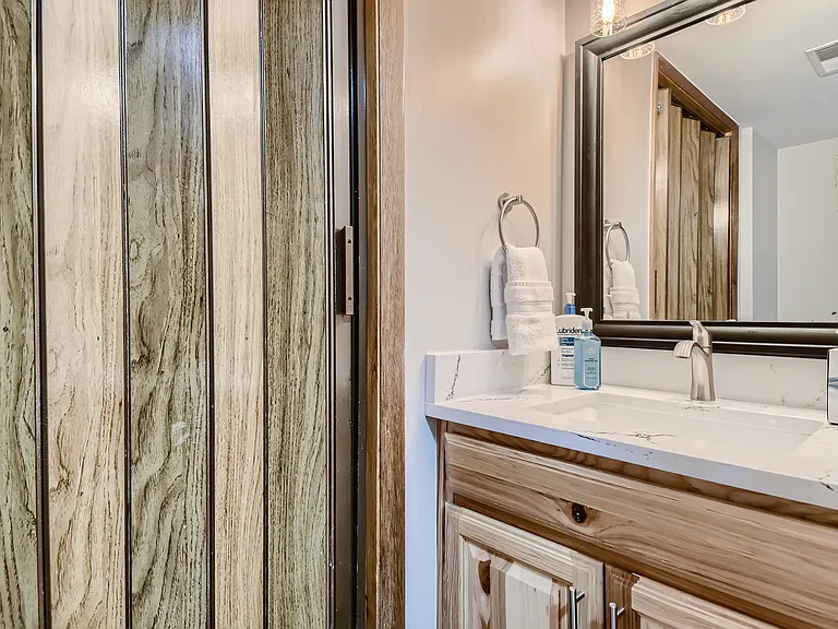 1/s bathroom with door to washer/dryer