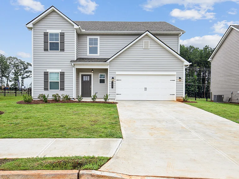 Exterior of the Hastings, two story home with a private driveway and attached garage.