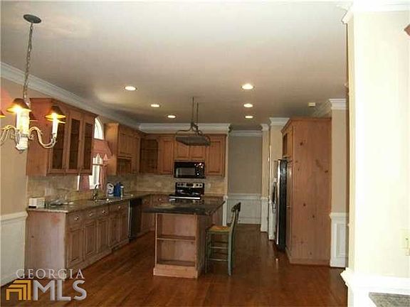 Kitchen with island with storage, granite counter tops, buil