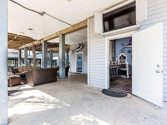 Outdoor area has POOL, HOT TUB, FIREPIT, OUTDOOR KITCHEN, TV'S GALORE, WINE FRIDGE, ICE MAKER, FULL SIZE FRIDGE, SMALL COOK TOP, UPGRADED SOUND SYSTEM