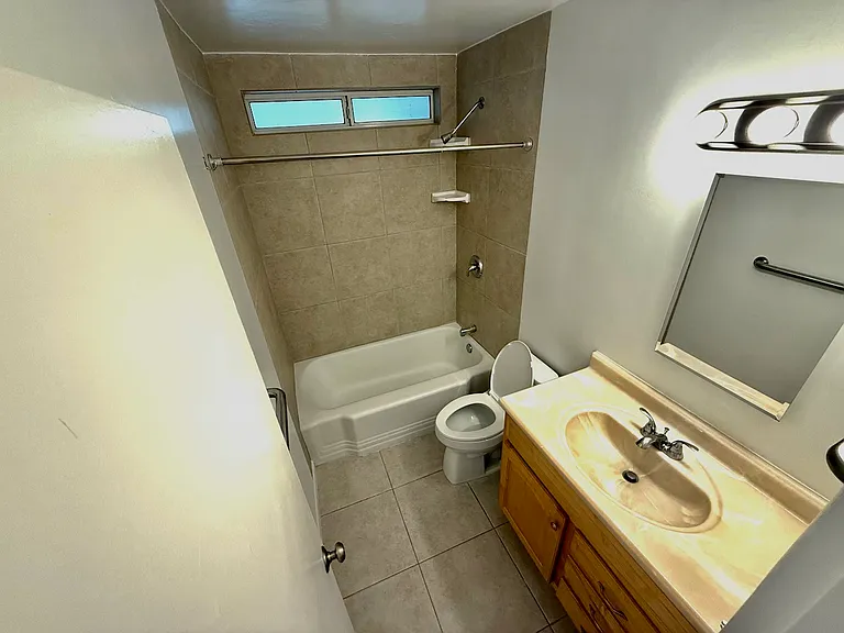 Main Bath 1, entrance from hall with the door right next to Bedroom 1