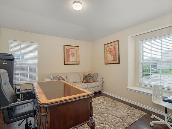 Recessed lighting, wood-finish flooring, and multiple windows with blinds