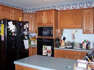 The kitchen is cozy, but provides ample cabinet storage.