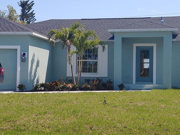 Front with stained concrete patio and walkway