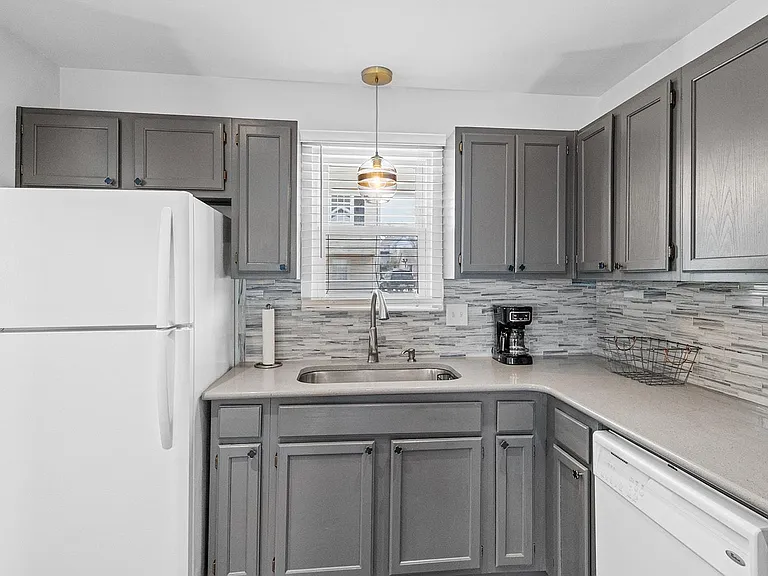 Kitchen includes refrigerator, dishwasher, oven and microwave.