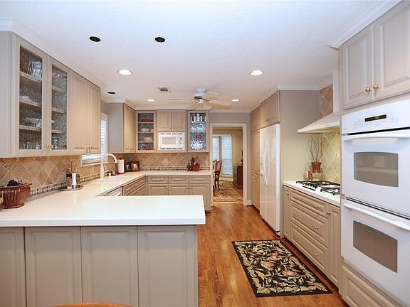 The updated kitchen has double ovens, recessed lighting and ample counter space.