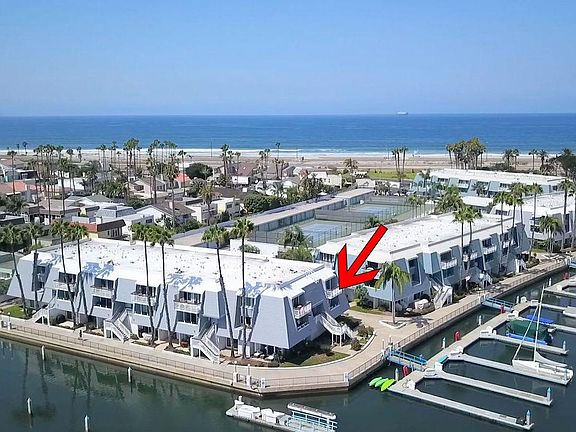 Upper corner end unit, overlooking marina & bay.
