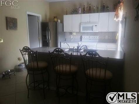 Nice size kitchen with breakfast bar.