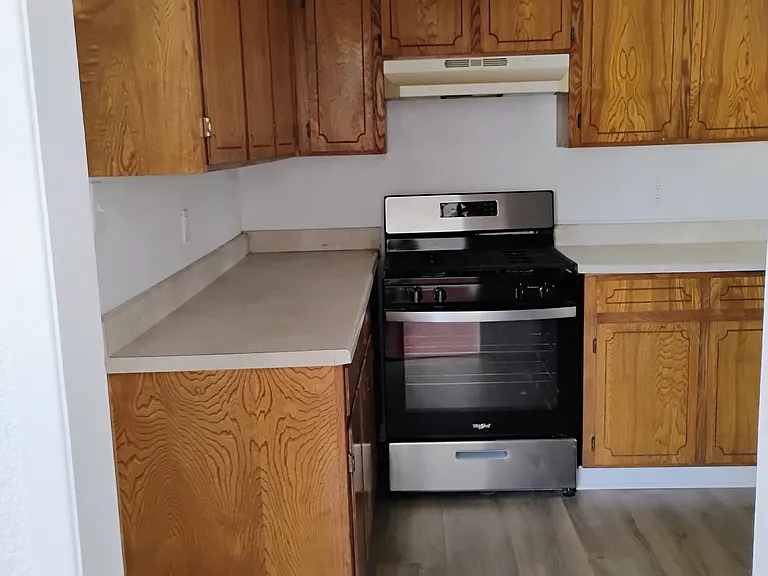 Different angle of kitchen showing more cabinets