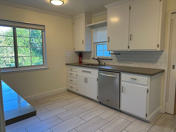 Beautiful quartz counter tops and new stainless-steel appliances with matching tile flooring.