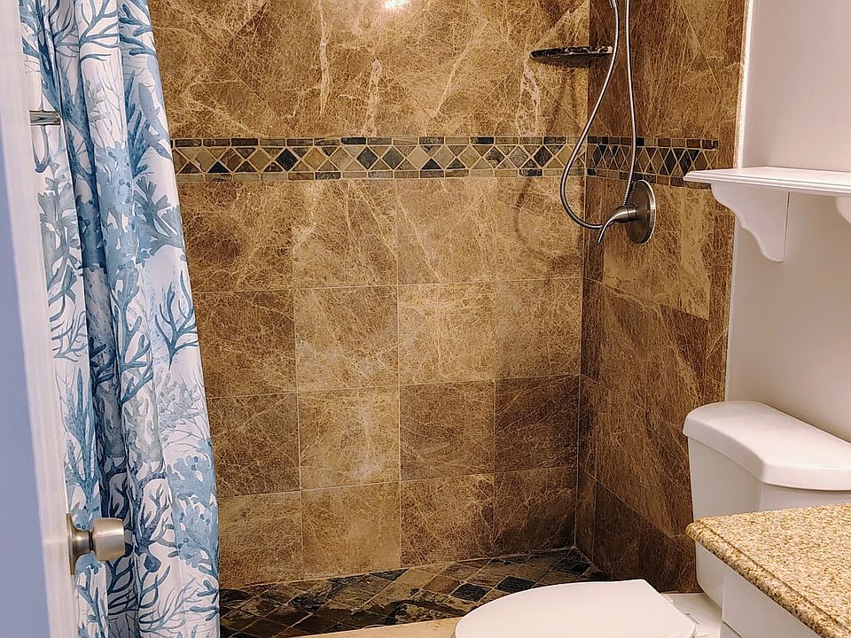 Main bathroom w/earth-tone marble/slate and granite; new curtain and showerhead!