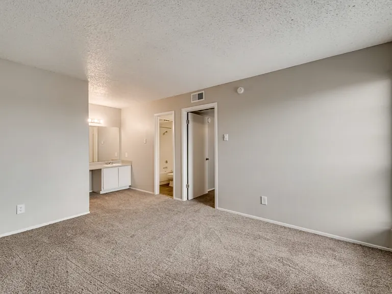 Spacious bedrooms with vanity and storage area.