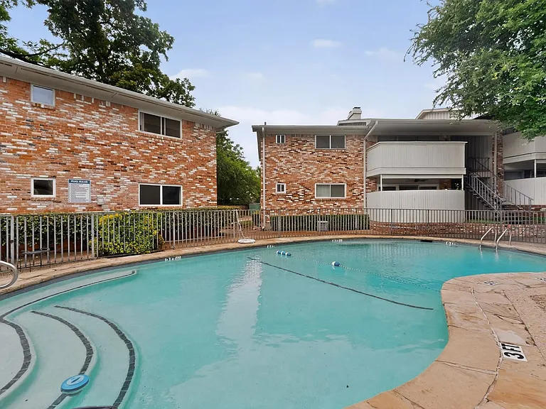 The outdoor swimming pool with a backdrop of trees