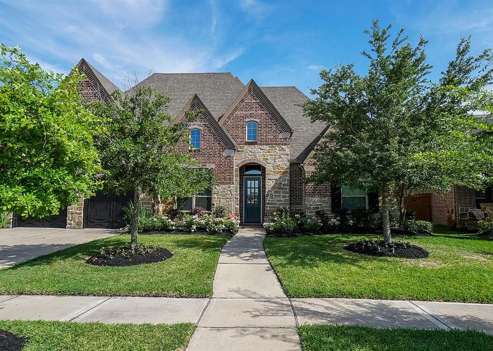 Welcome Home to 17219 Bland Mills Ln. This home has great curb appeal with a beautiful brick and stone exterior and well-manicured landscaping.
