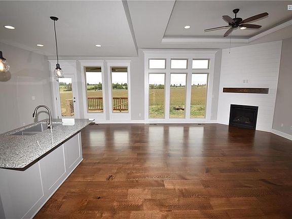 Tons of Hardwood Floors included in price, Hardwood at Glorious long and wide Entryway, in the Great Room and Kitchen/Breakfast areas. Hardwood all over, with carpet in Bedrooms, and Tile Floors in all baths and Laundry Room