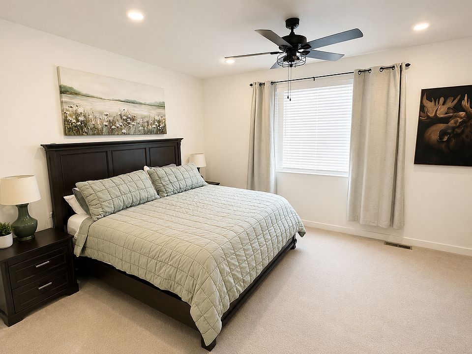 Large primary bedroom with walk-in closet, high ceilings and attached bathroom.