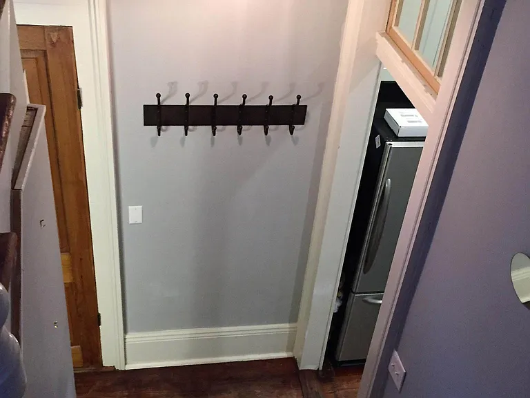 Perspective from staircase (guest bedroom/home office and half bath to left & kitchen, dining rm & living rm to the right)