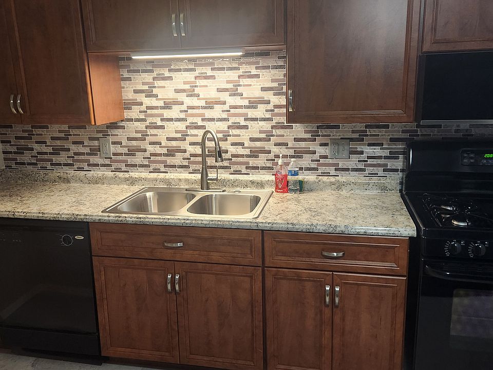 Full size kitchen with 18cu Fridge, 4 burner Gas Range, Microwave, Dishwasher, wall mounted folding table. New Cabinets with Soft Close Doors & Drawers