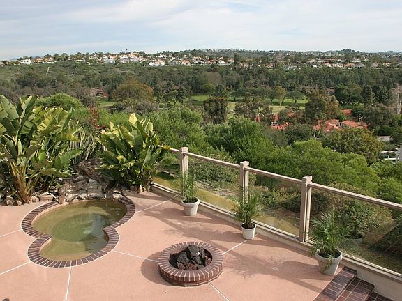Back yard with spa, waterfall, firepit & expansive view looking south east