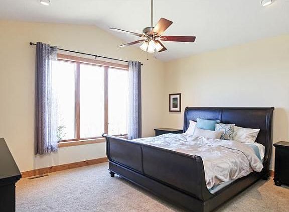 Main level master bedroom w/ vaulted ceiling & walk in closet.