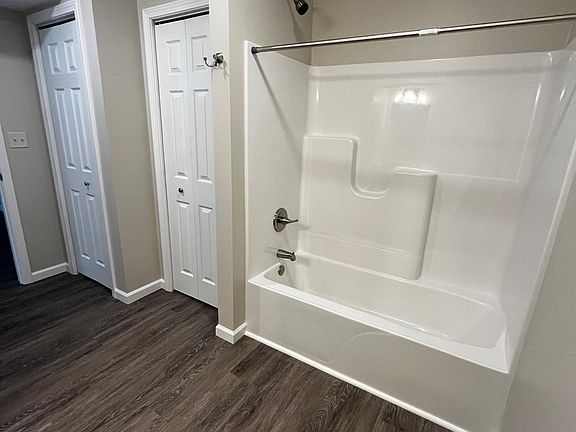 spacious bathroom , with shower and storage closet.