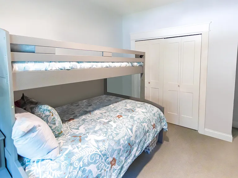 Bedroom two has a full size bunk bed on the bottom and a single bunk on top.