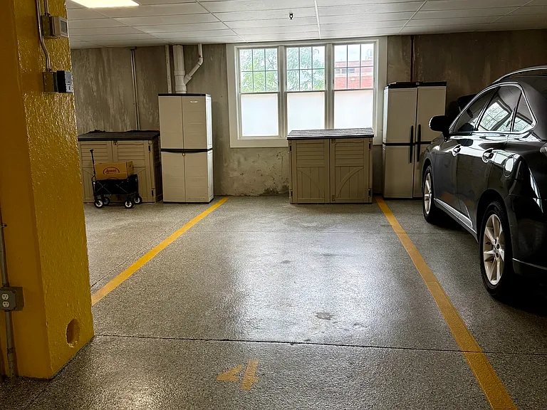 Dedicated parking spot with storage unit