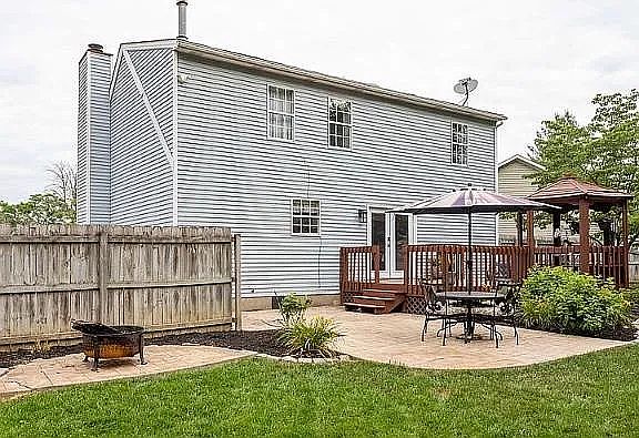 Back yard pic showing porch, gazebo, table/chair and outdoor fire pit area
